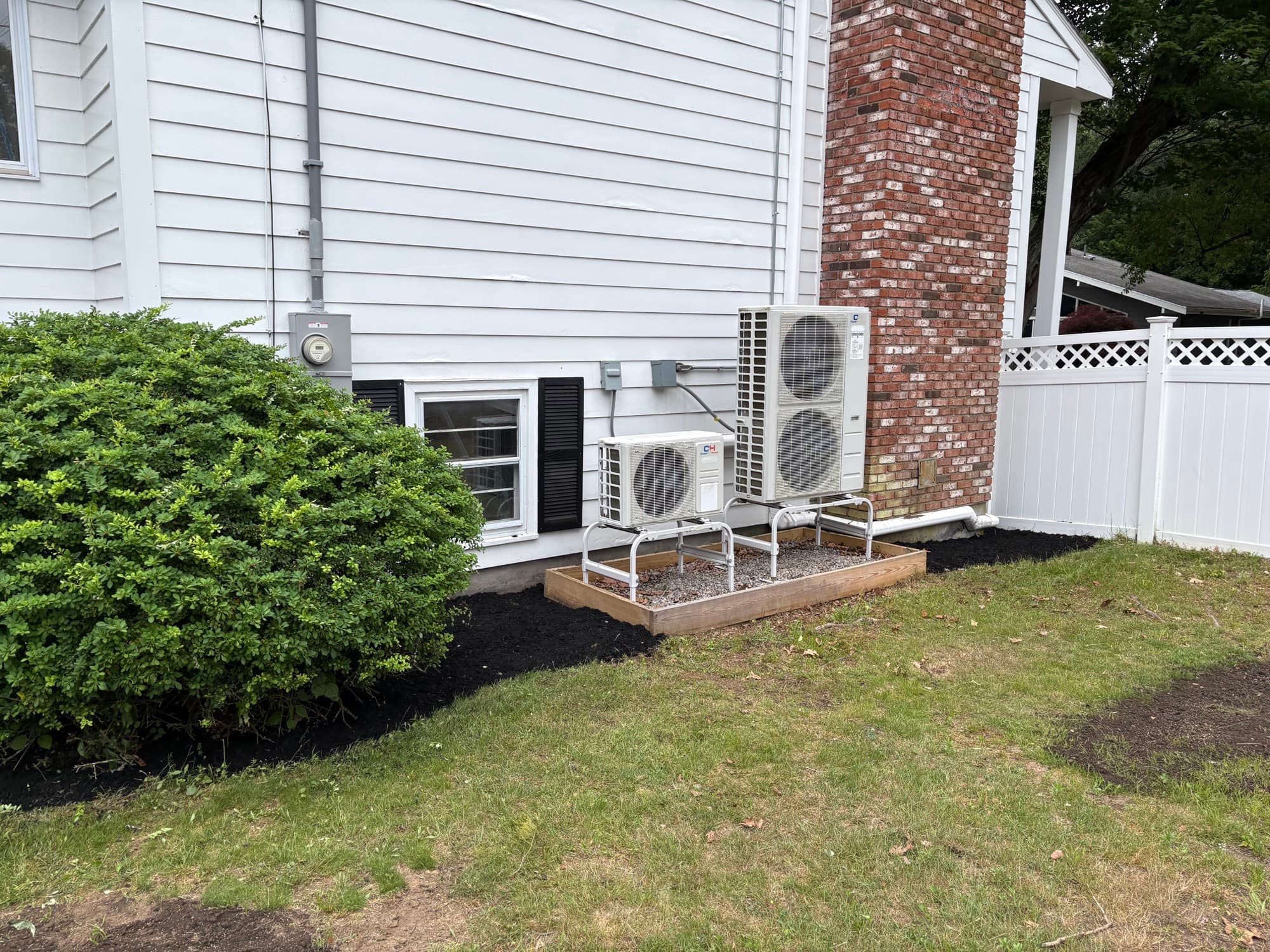 Clean mulch bed and gravel pad around outdoor HVAC units